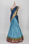 Light blue shade plain lehanga featuring contrasting zari border and blouse paired with dark blue shawl