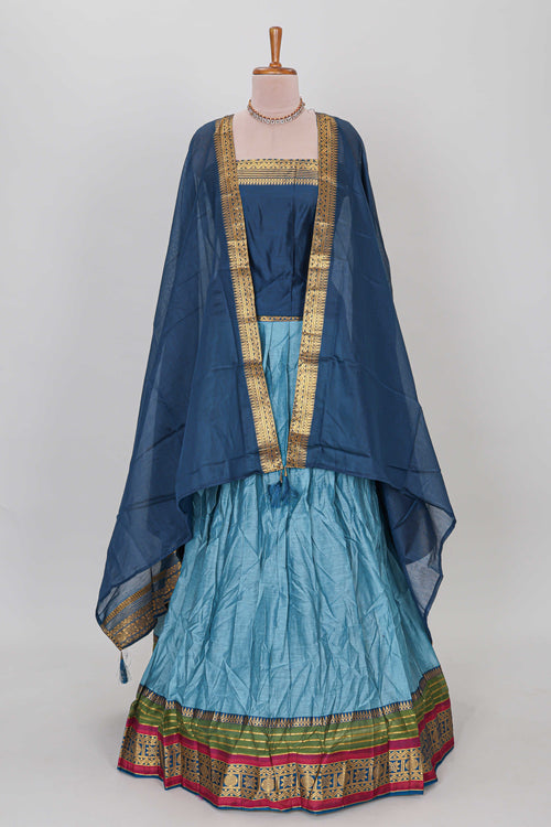 Light blue shade plain lehanga featuring contrasting zari border and blouse paired with dark blue shawl