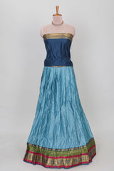 Light blue shade plain lehanga featuring contrasting zari border and blouse paired with dark blue shawl