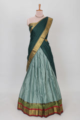 Green shade plain lehanga featuring contrasting zari border and blouse paired with pine green shawl