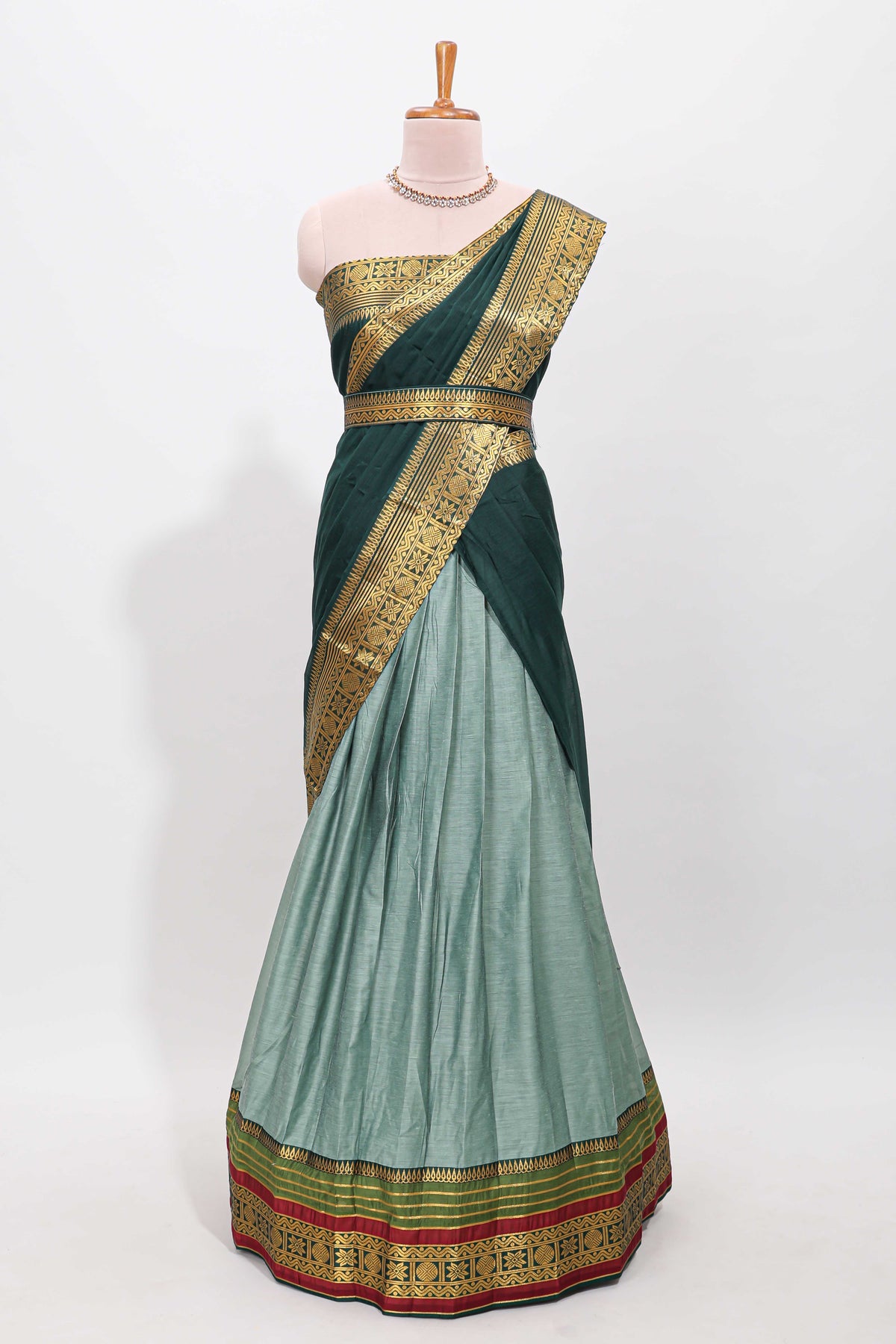 Green shade plain lehanga featuring contrasting zari border and blouse paired with pine green shawl