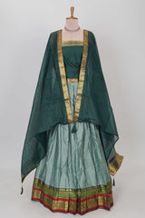 Green shade plain lehanga featuring contrasting zari border and blouse paired with pine green shawl