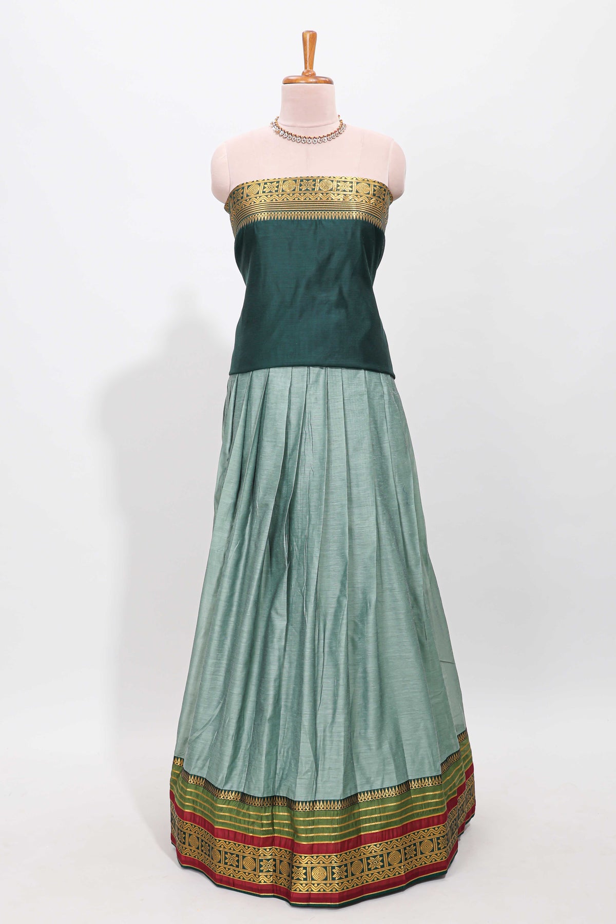 Green shade plain lehanga featuring contrasting zari border and blouse paired with pine green shawl