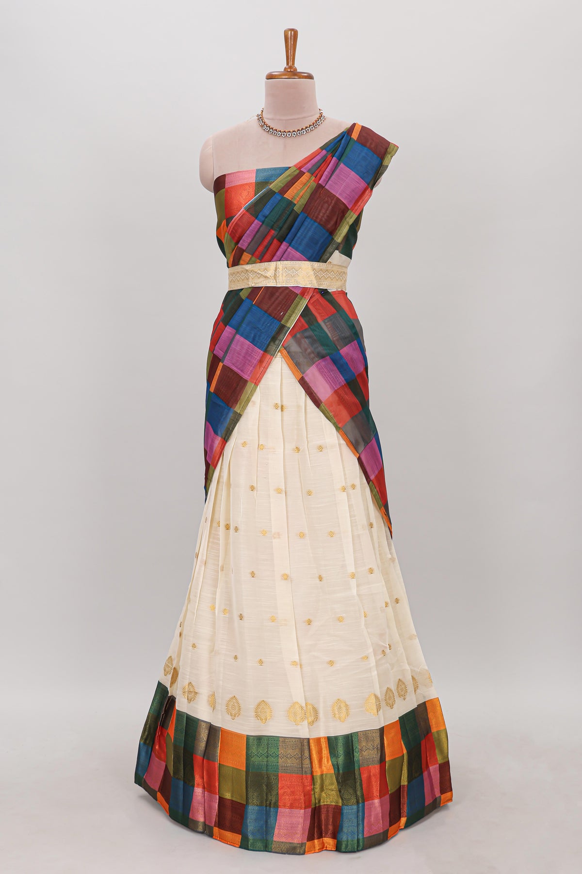 White zari butta designed lehanga featuring matching blouse paired with dhavani featuring madras checks