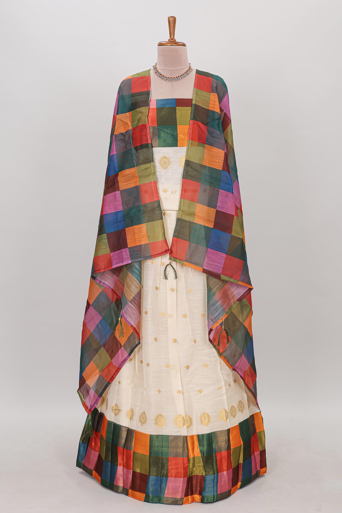 White zari butta designed lehanga featuring matching blouse paired with dhavani featuring madras checks