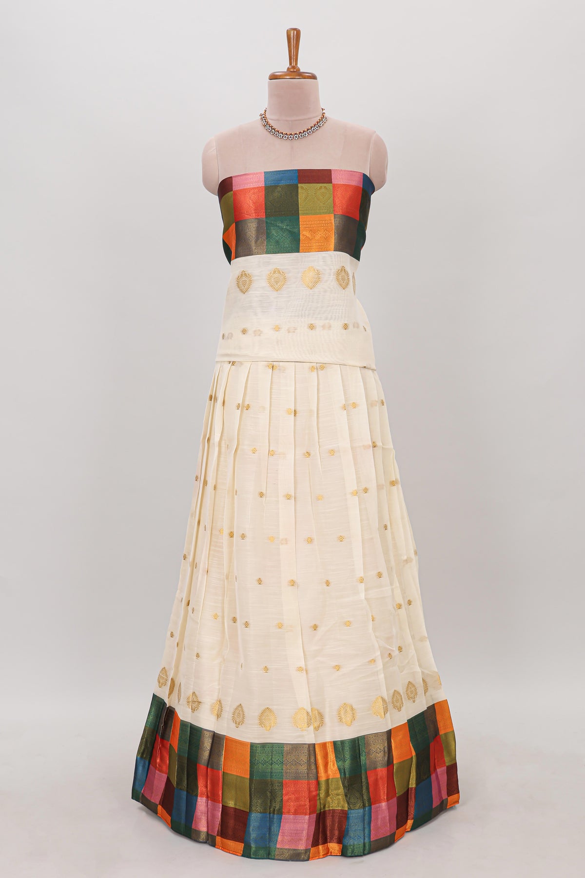 White zari butta designed lehanga featuring matching blouse paired with dhavani featuring madras checks