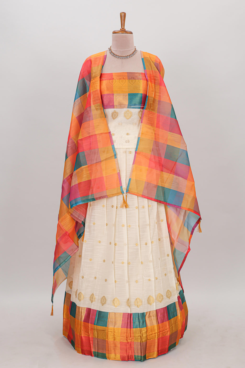 White zari butta designed lehanga featuring matching blouse paired with multicolor dhavani featuring madras checks