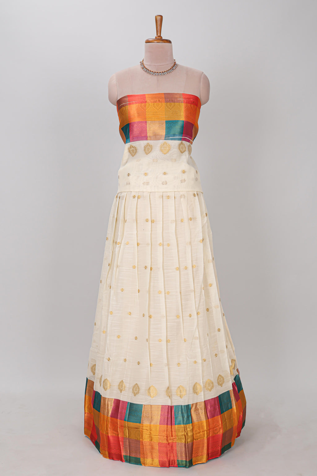 White zari butta designed lehanga featuring matching blouse paired with multicolor dhavani featuring madras checks