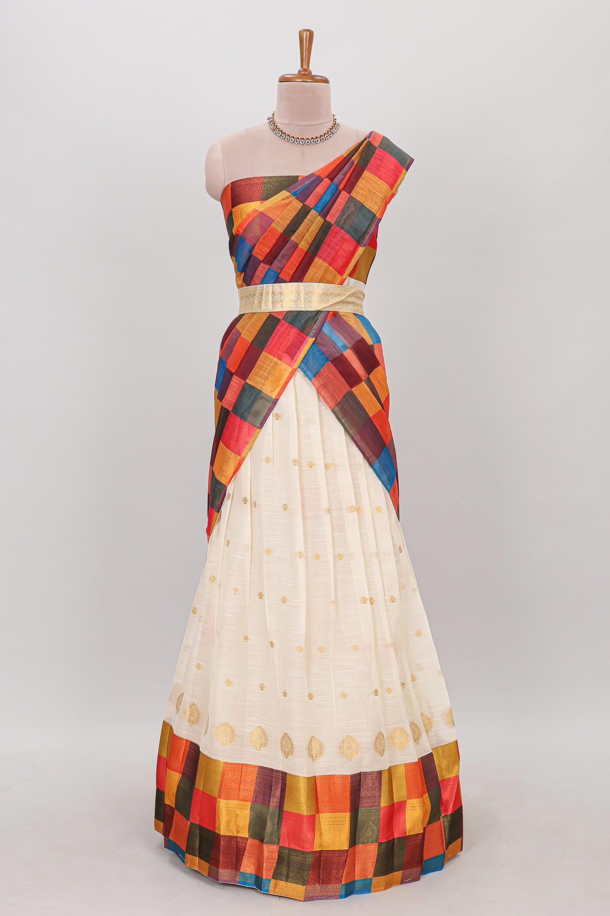 White zari butta designed lehanga featuring matching blouse paired with multicolor dhavani featuring madras checks