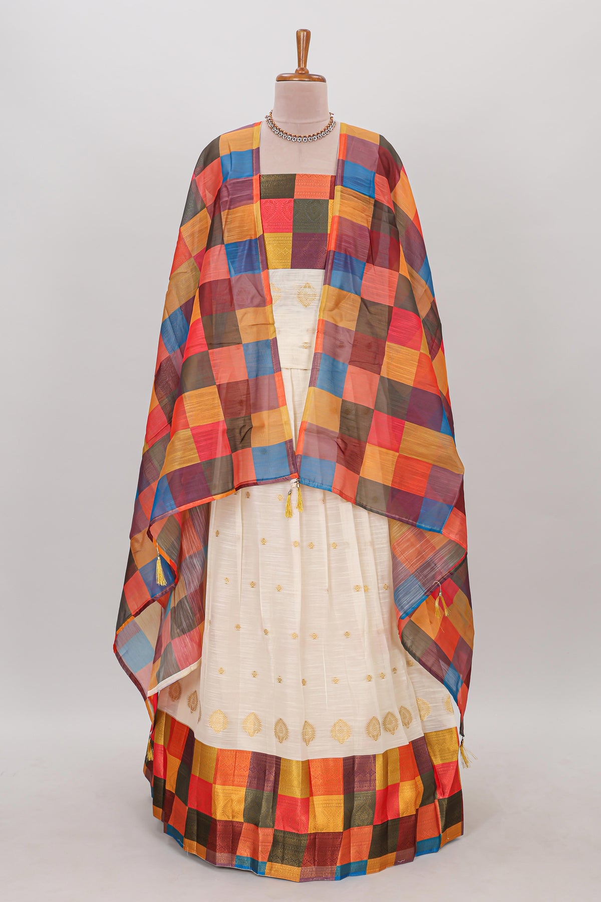 White zari butta designed lehanga featuring matching blouse paired with multicolor dhavani featuring madras checks