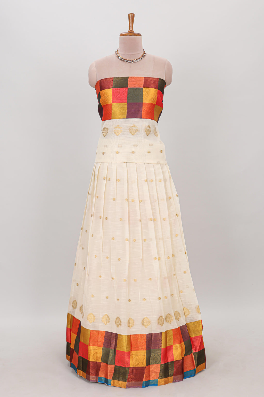 White zari butta designed lehanga featuring matching blouse paired with multicolor dhavani featuring madras checks