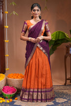 Orange plain half saree with matching blouse and contrast zari border and dhavani