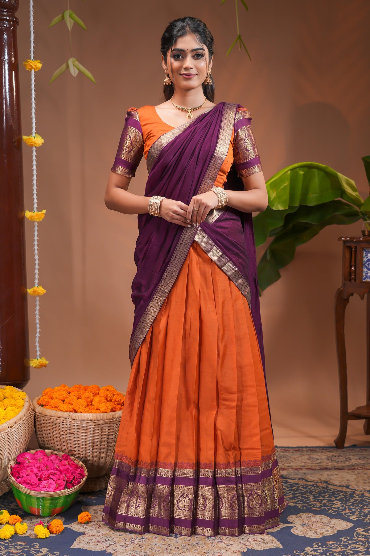 Orange plain half saree with matching blouse and contrast zari border and dhavani