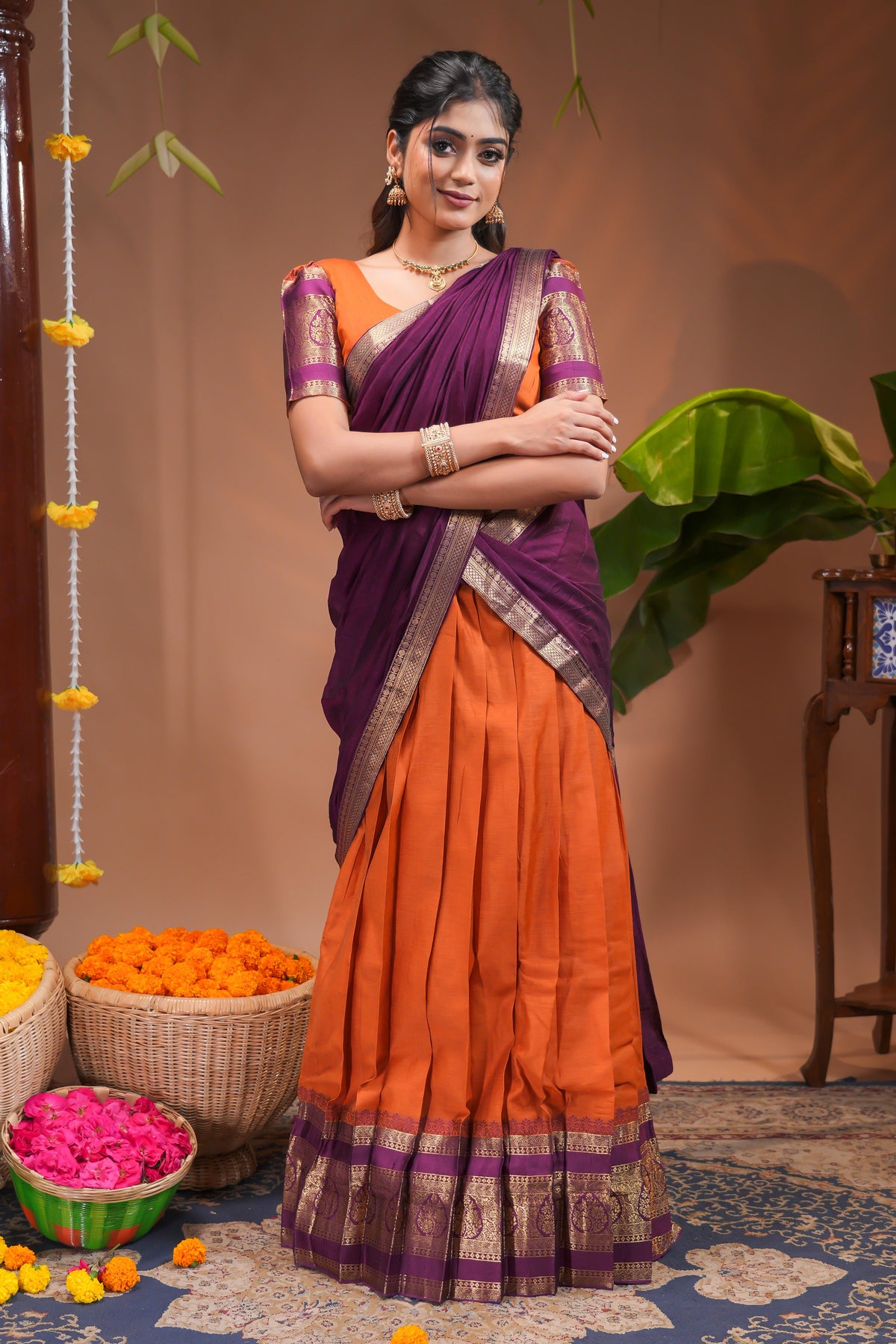 Orange plain half saree with matching blouse and contrast zari border and dhavani