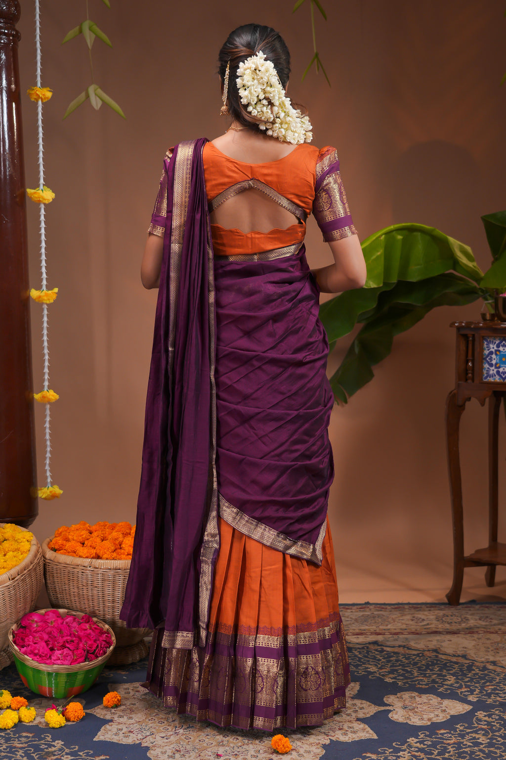 Orange plain half saree with matching blouse and contrast zari border and dhavani