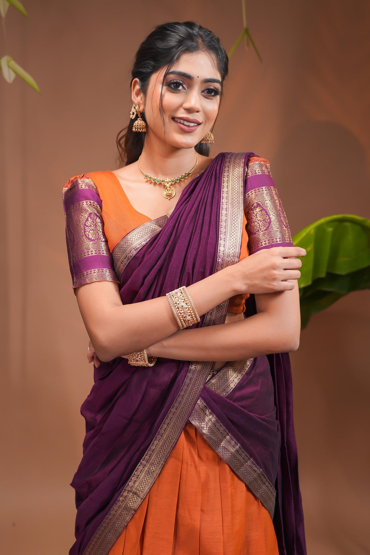 Orange plain half saree with matching blouse and contrast zari border and dhavani