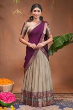 Beige plain half saree with matching blouse and contrast zari border and dhavani