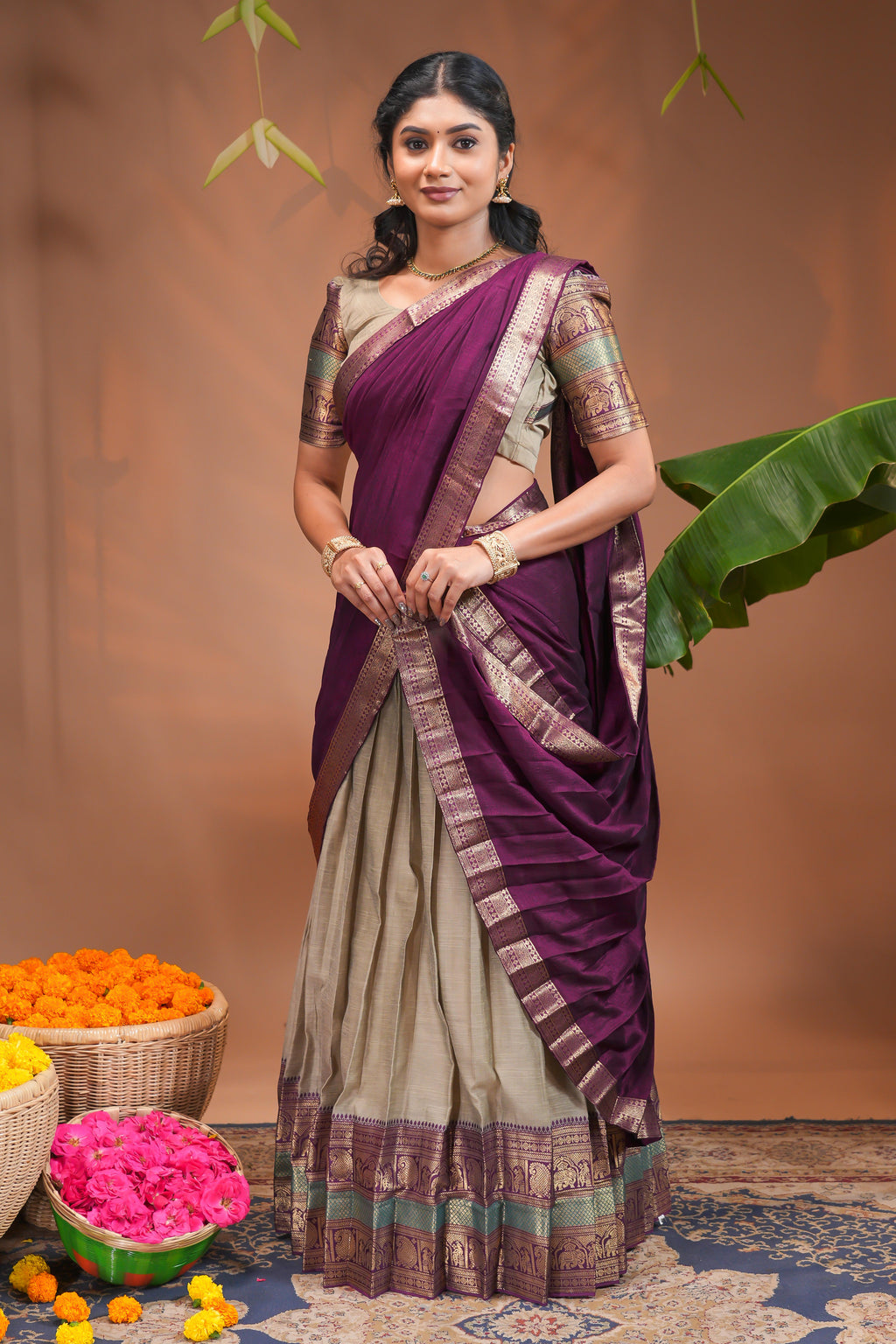 Beige plain half saree with matching blouse and contrast zari border and dhavani