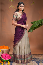 Beige plain half saree with matching blouse and contrast zari border and dhavani