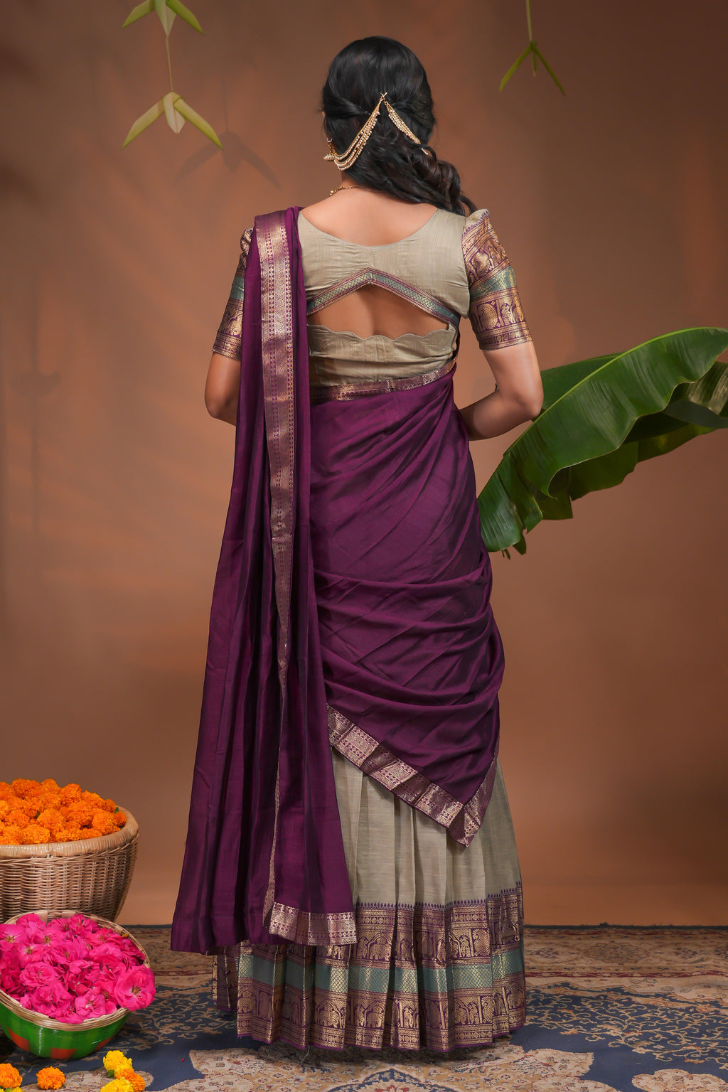 Beige plain half saree with matching blouse and contrast zari border and dhavani