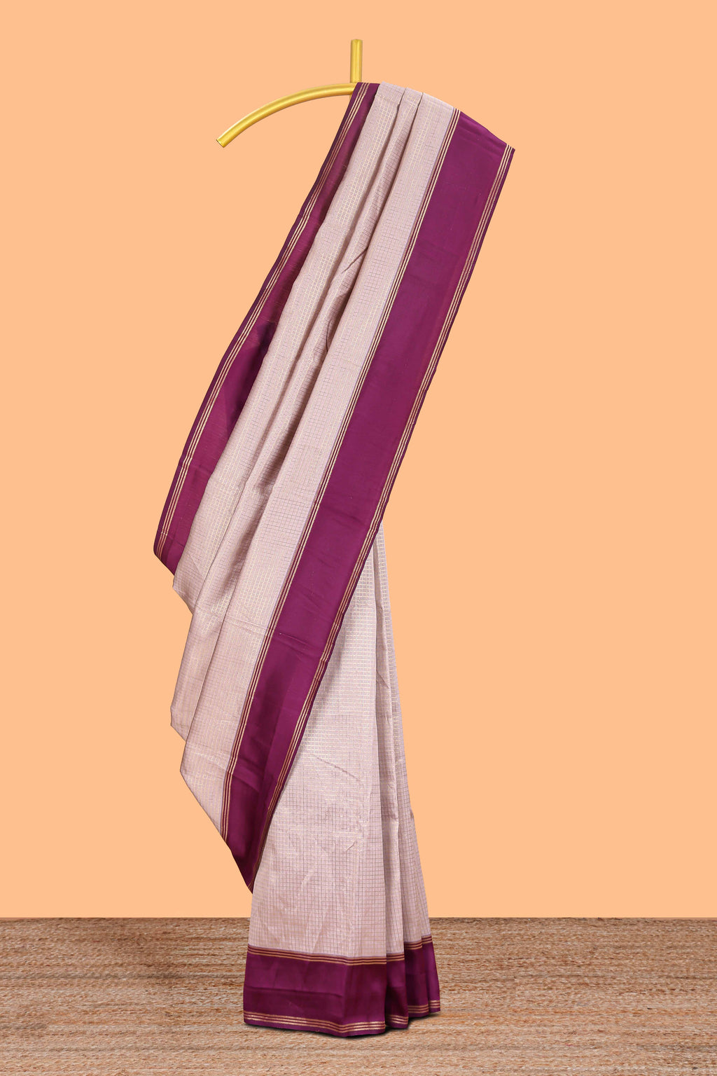 Cream zari checked art litchi silk saree with contrast border and floral zari butta blouse