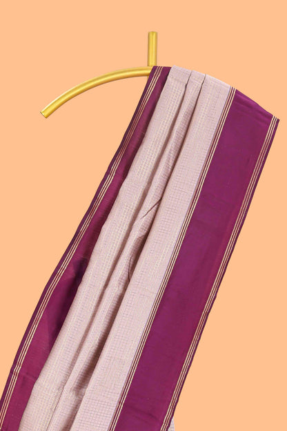 Cream zari checked art litchi silk saree with contrast border and floral zari butta blouse