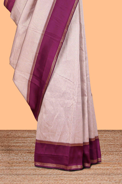 Cream zari checked art litchi silk saree with contrast border and floral zari butta blouse