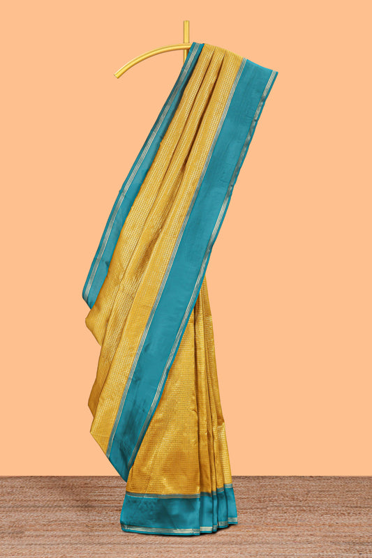 Golden yellow zari checked art litchi silk saree with contrast border and zari butta blouse