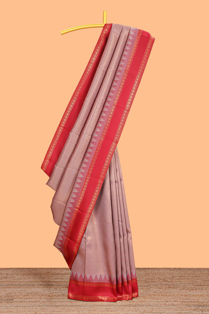 Peach checked geometric design litchi silk saree with contrast ikkat style bentex zari border and blouse