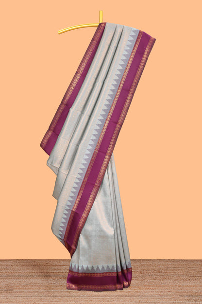 Turquoise green checked geometric design litchi silk saree with contrast ikkat style bentex zari border and blouse