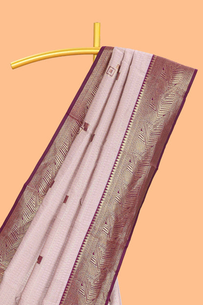 Pale pink checked geometric design litchi silk saree with contrast zari border and blouse
