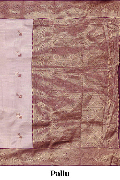 Pale pink checked geometric design litchi silk saree with contrast zari border and blouse