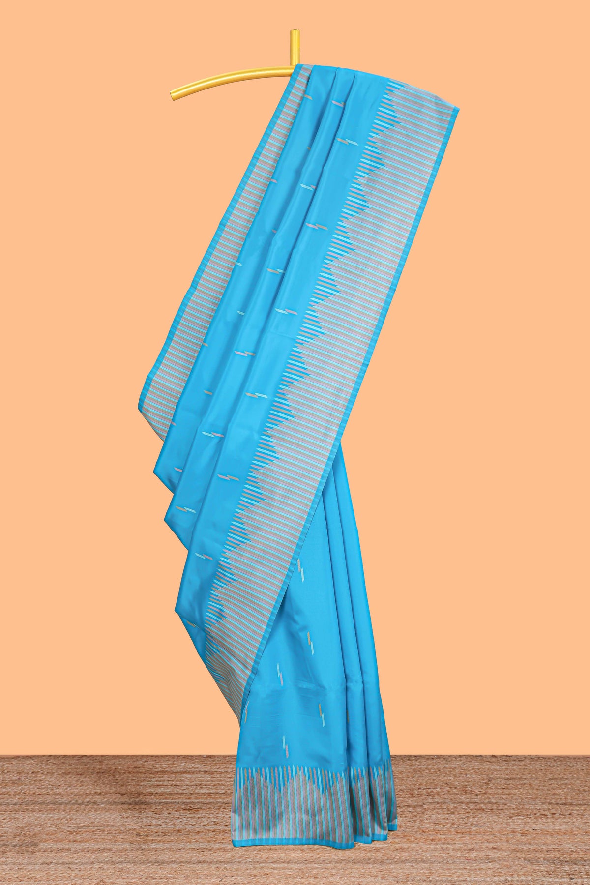 Blue geometric style motifs litchi silk saree with contrast striped border and blouse