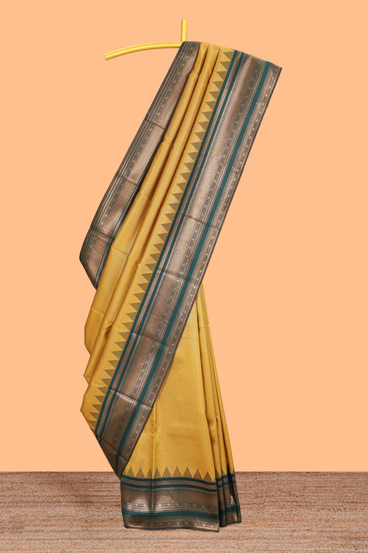 Mustard zari textured litchi silk saree with contrast zari border and floral motifs blouse