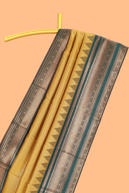 Mustard zari textured litchi silk saree with contrast zari border and floral motifs blouse