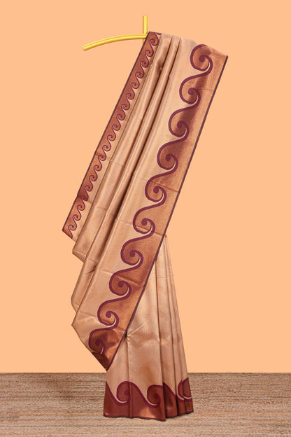 Beige chevron zari design litchi silk saree with contrast swirl shape zari border and blouse