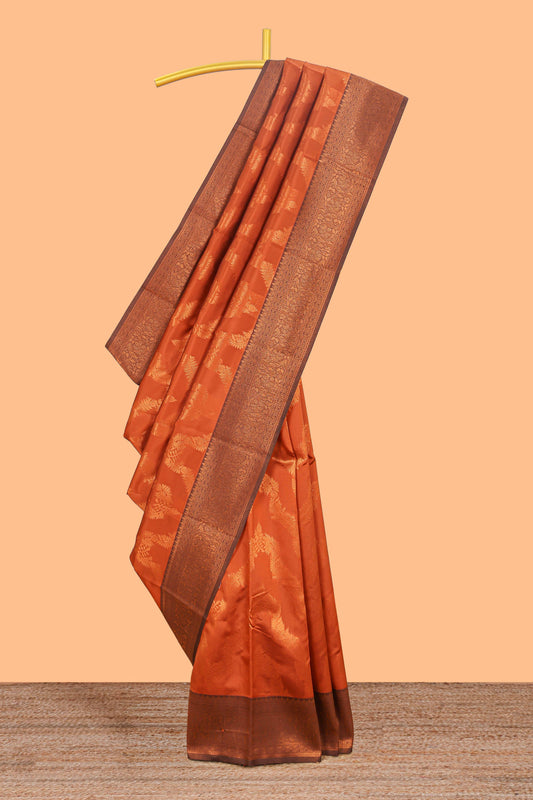 Orange chevron zari design litchi silk saree with contrast zari design border and contrast blouse