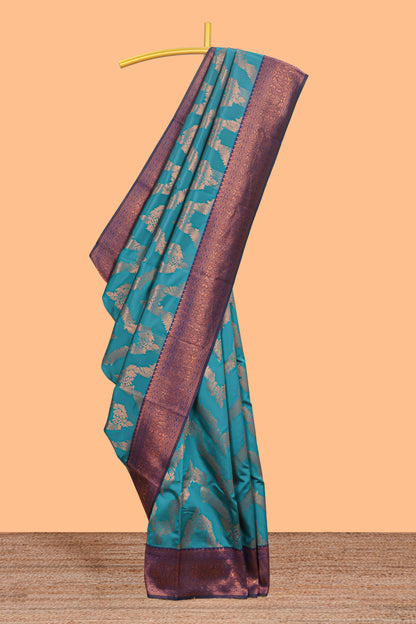 Jade green chevron zari design litchi silk saree with contrast zari design border and contrast blouse