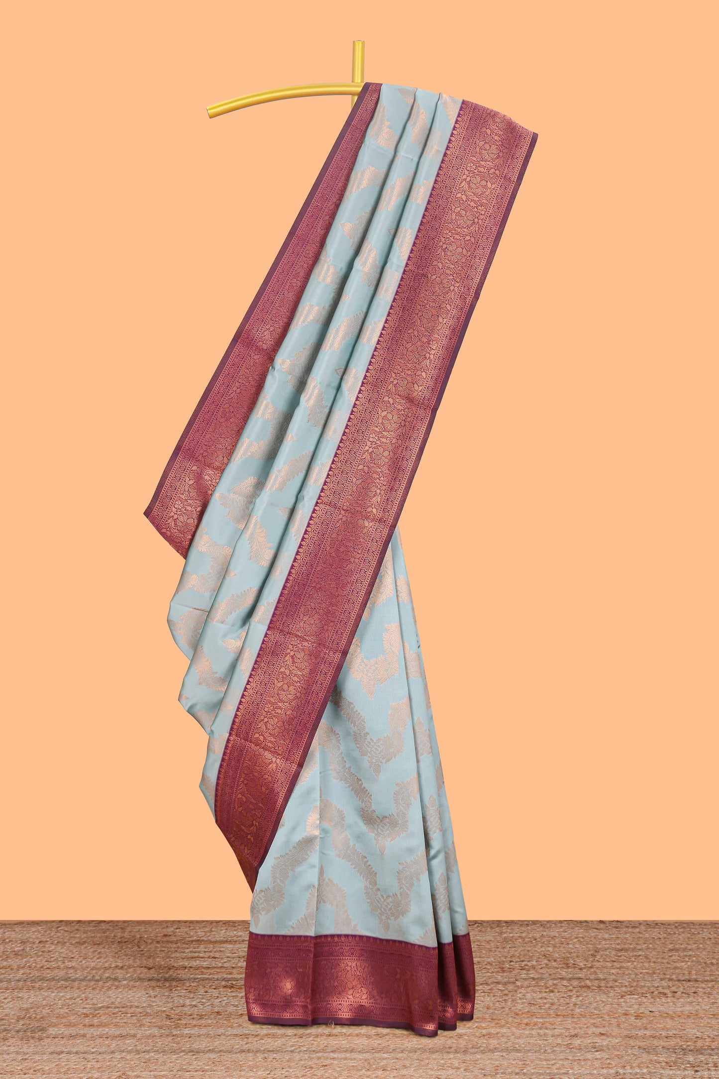 Baby blue chevron zari design litchi silk saree with contrast zari design border and contrast blouse
