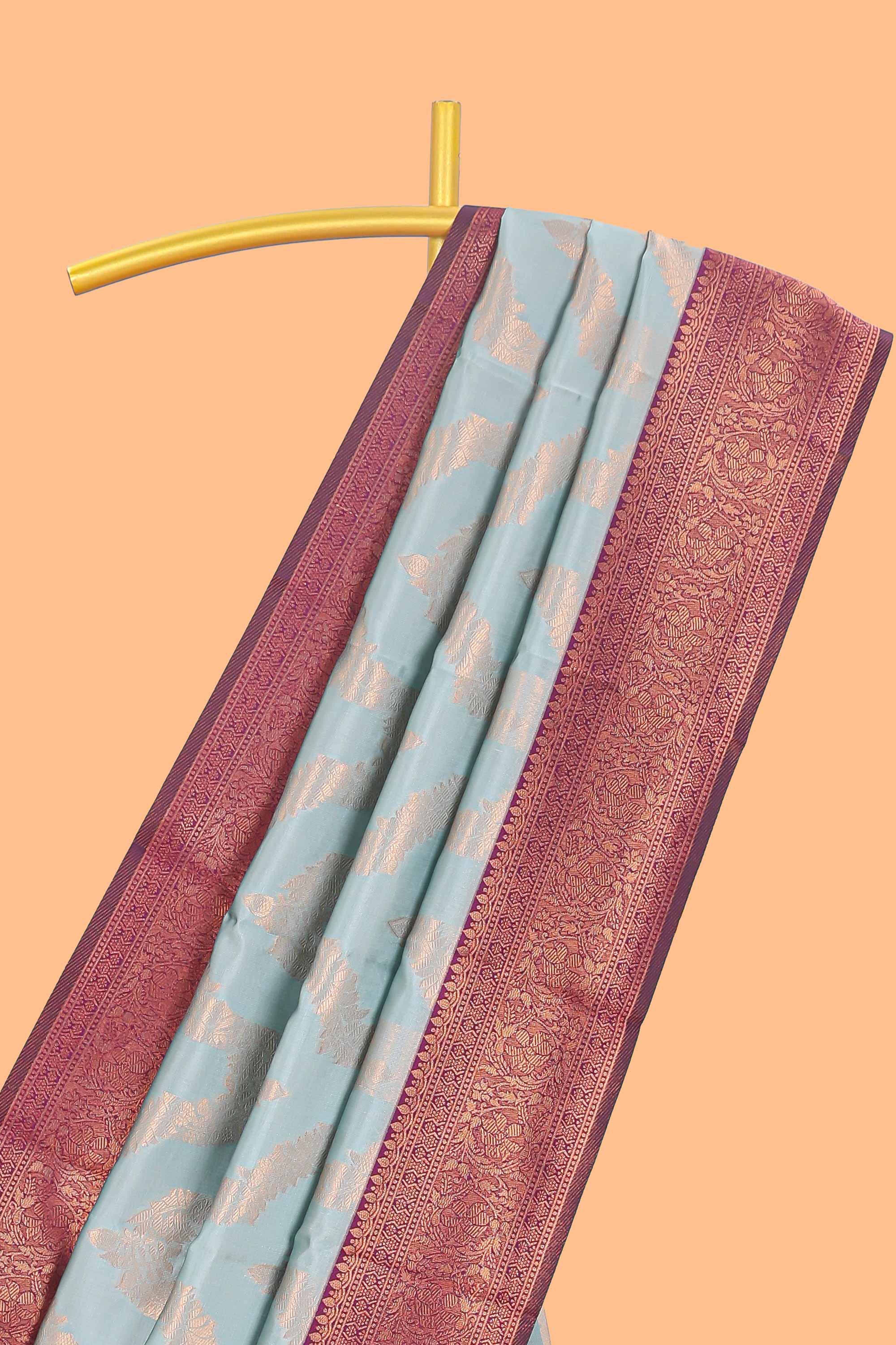 Baby blue chevron zari design litchi silk saree with contrast zari design border and contrast blouse