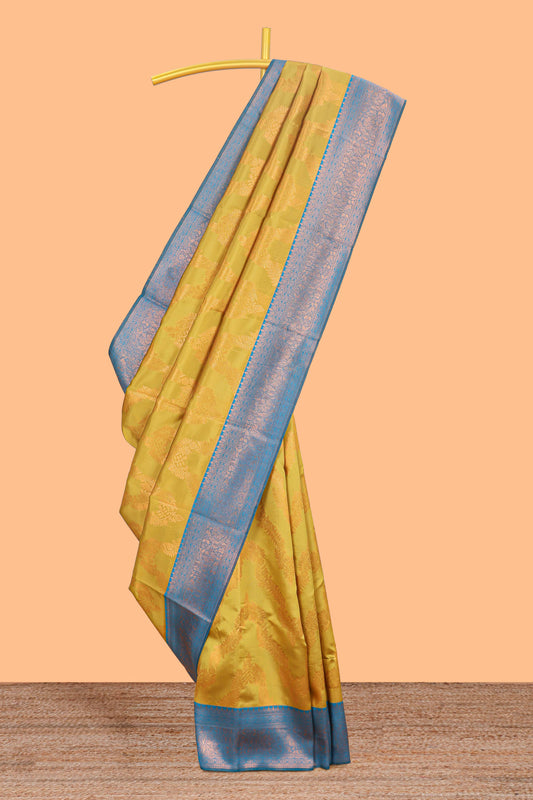 Mustard chevron zari design litchi silk saree with contrast zari design border and contrast blouse