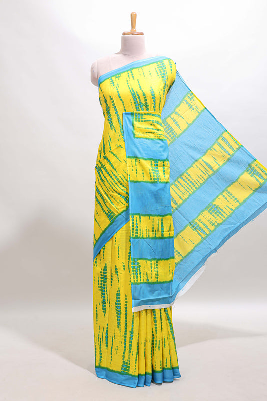 Yellow shibori print mul mul cotton saree with contrast border and floral printed blouse