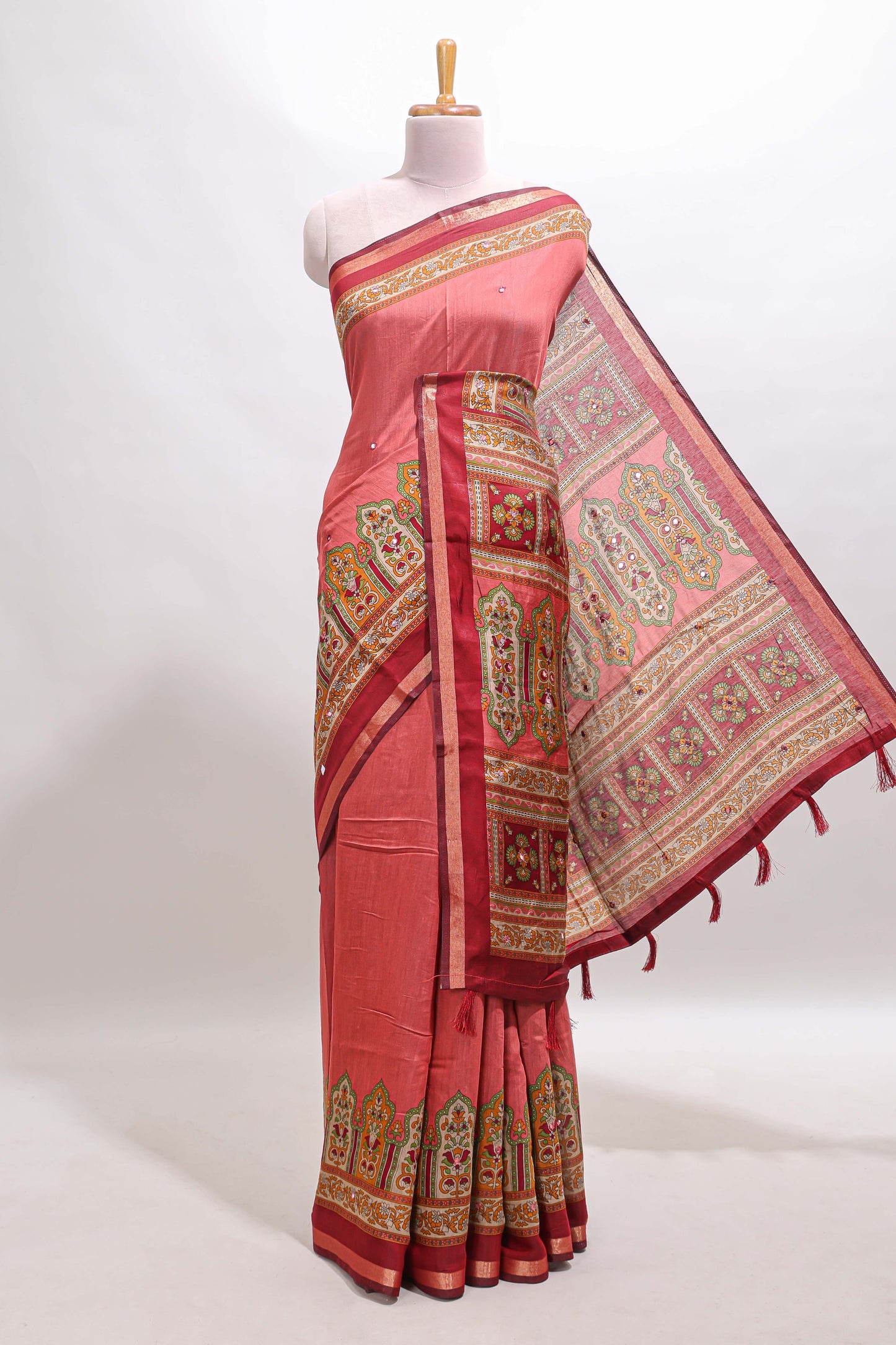 Peach printed marsh mellow saree with contrast floral border and tassel pallu