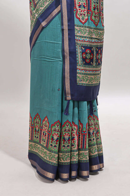 Blue printed marsh mellow saree with contrast floral border and tassel pallu