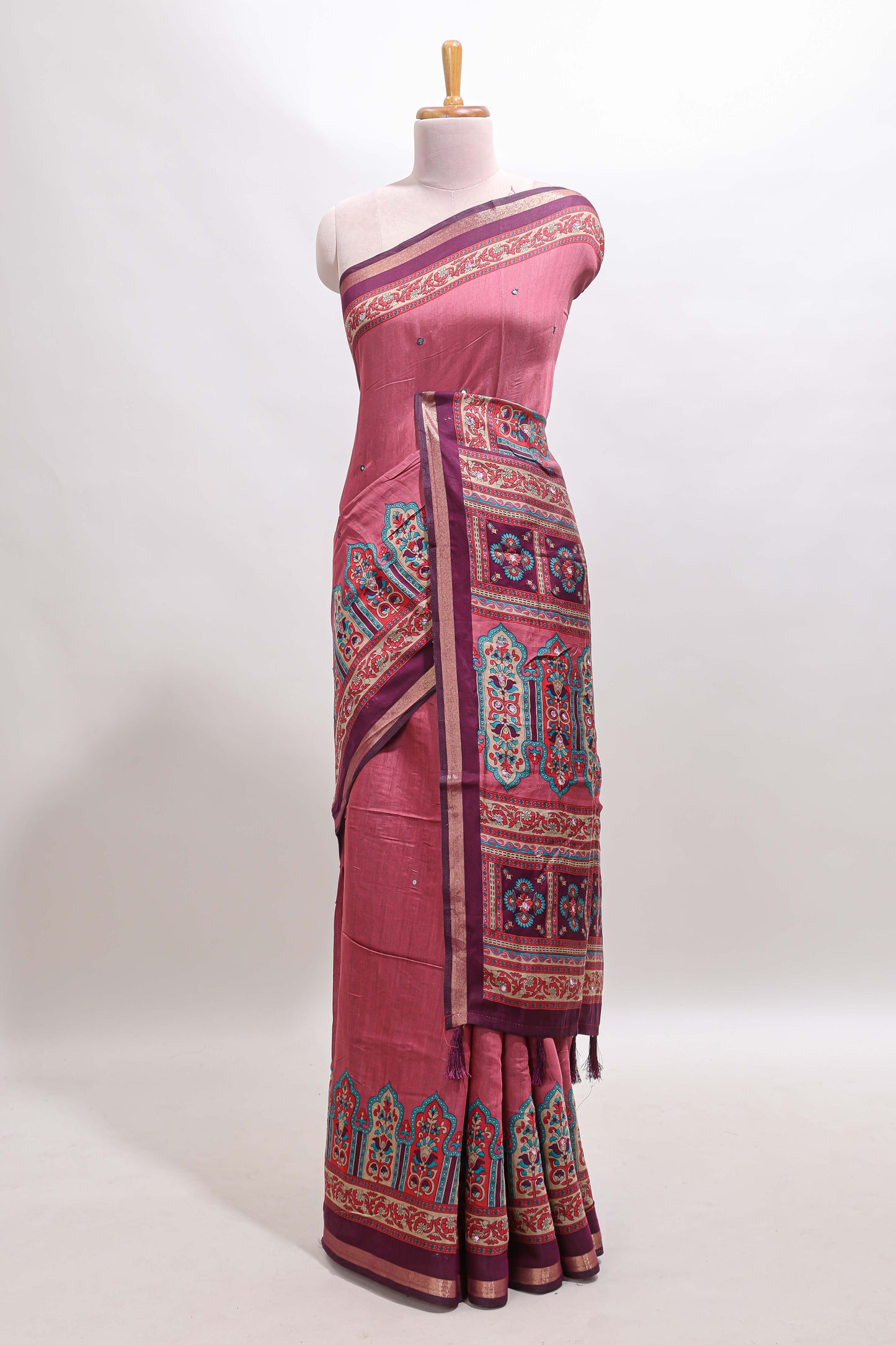 Peach printed marsh mellow saree with contrast floral border and tassel pallu
