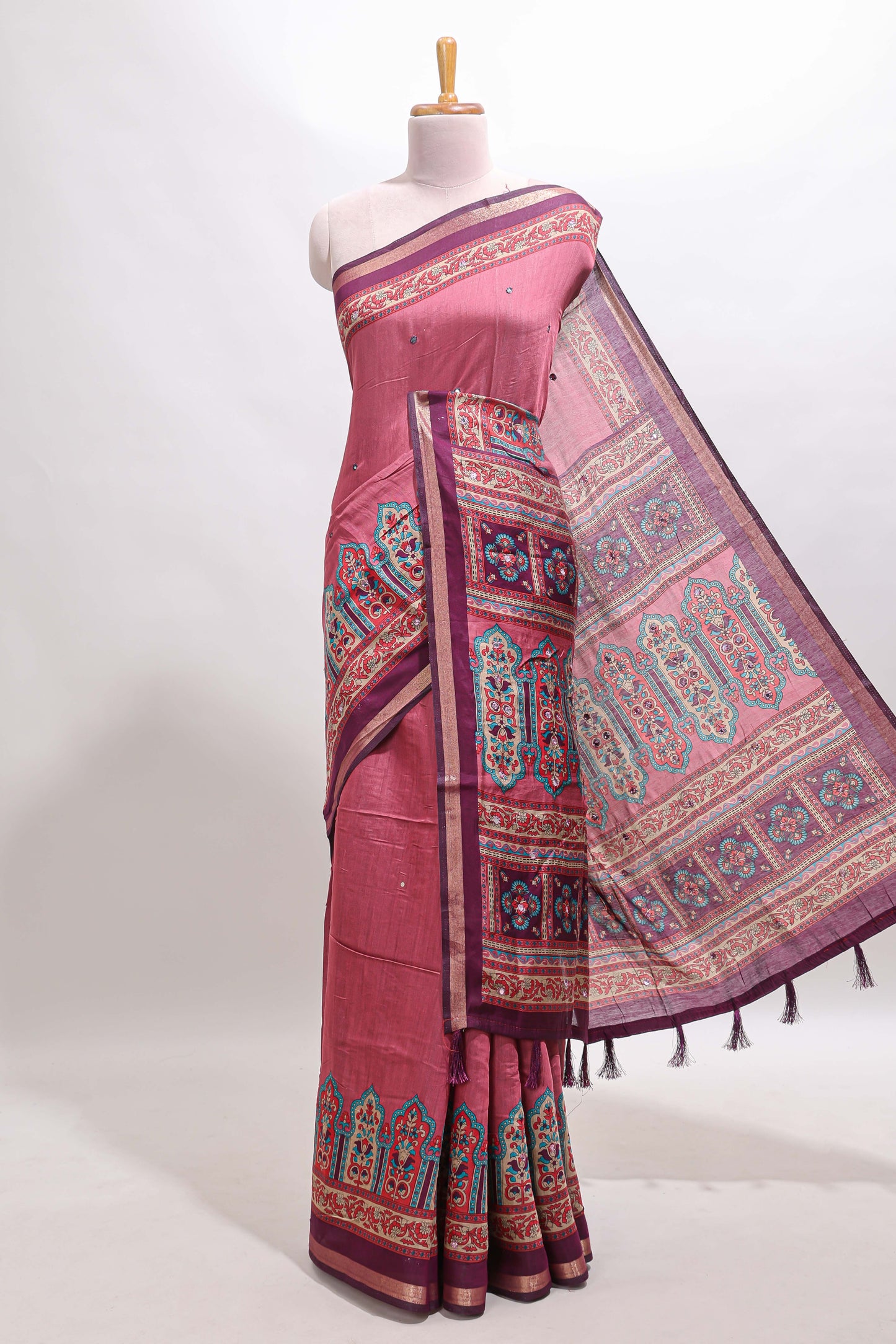Peach printed marsh mellow saree with contrast floral border and tassel pallu