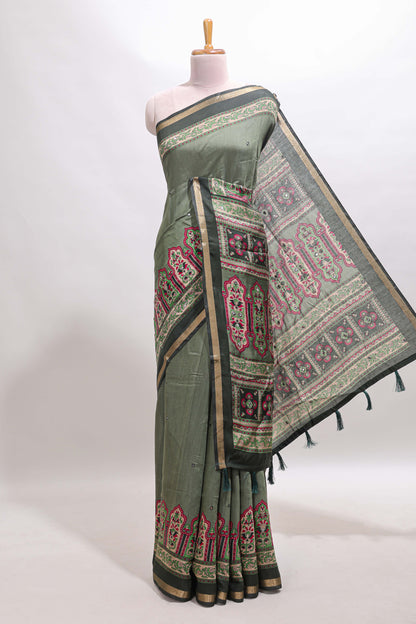 Green printed marsh mellow saree with contrast floral border and tassel pallu