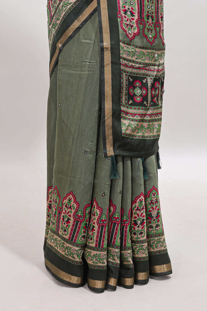 Green printed marsh mellow saree with contrast floral border and tassel pallu