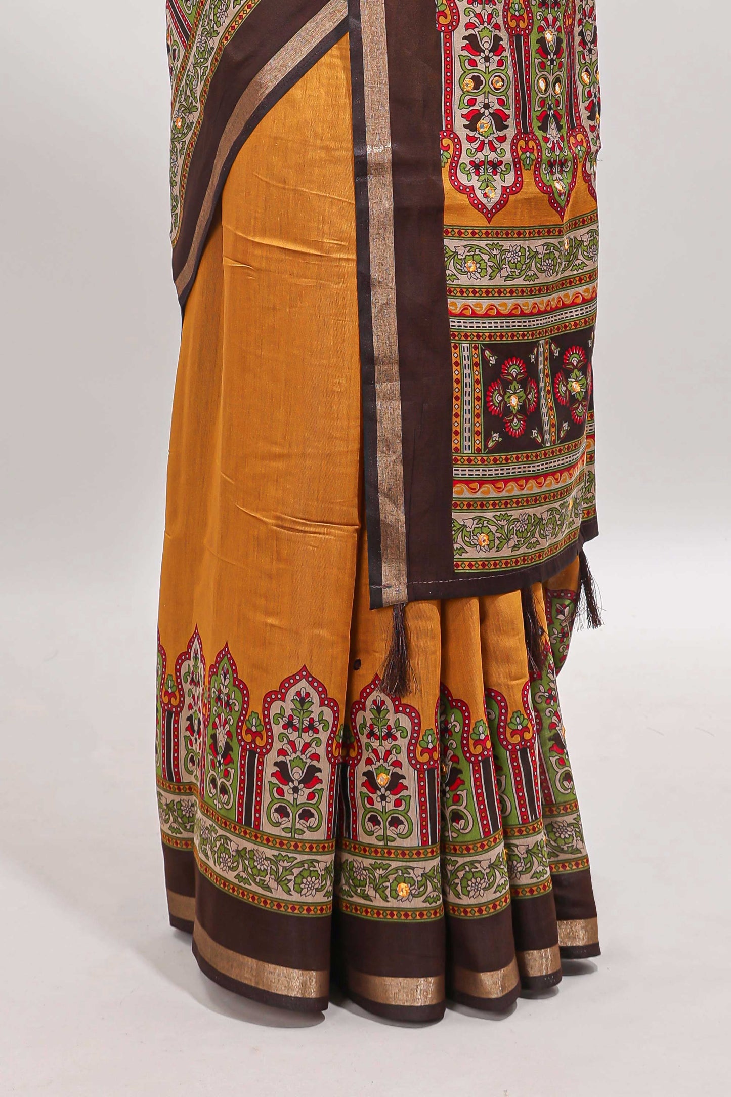 Mustard printed marsh mellow saree with contrast floral border and tassel pallu