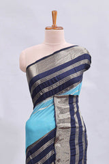 Blue zari design mushru silk saree with contrast striped zari border and blouse
